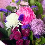 Beautiful flower arrangement featuring mums and disbuds in a decorative box